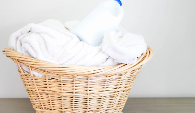 Laundry-Basket-with-White-Clothes-and-Detergent-On