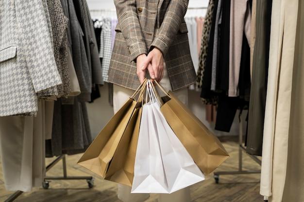 close-up-hands-holding-shopping-bags