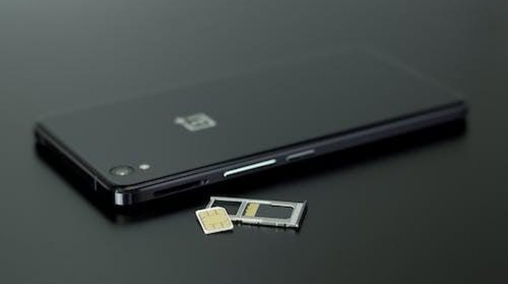 communication-black-smartphone-on-black-table-stock-photos