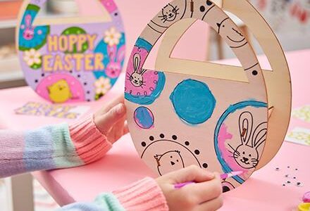 child's hands making wood Easter craft