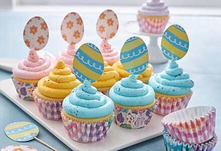 pink, yellow and blue Easter cupcakes with decorations