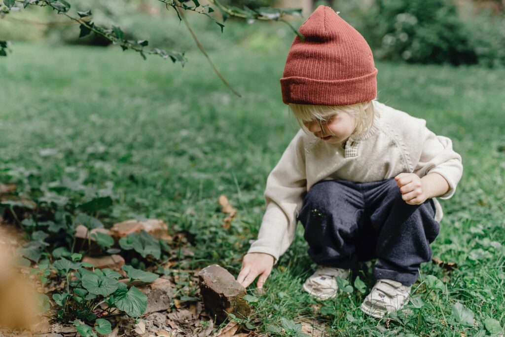 little boy exploring stone