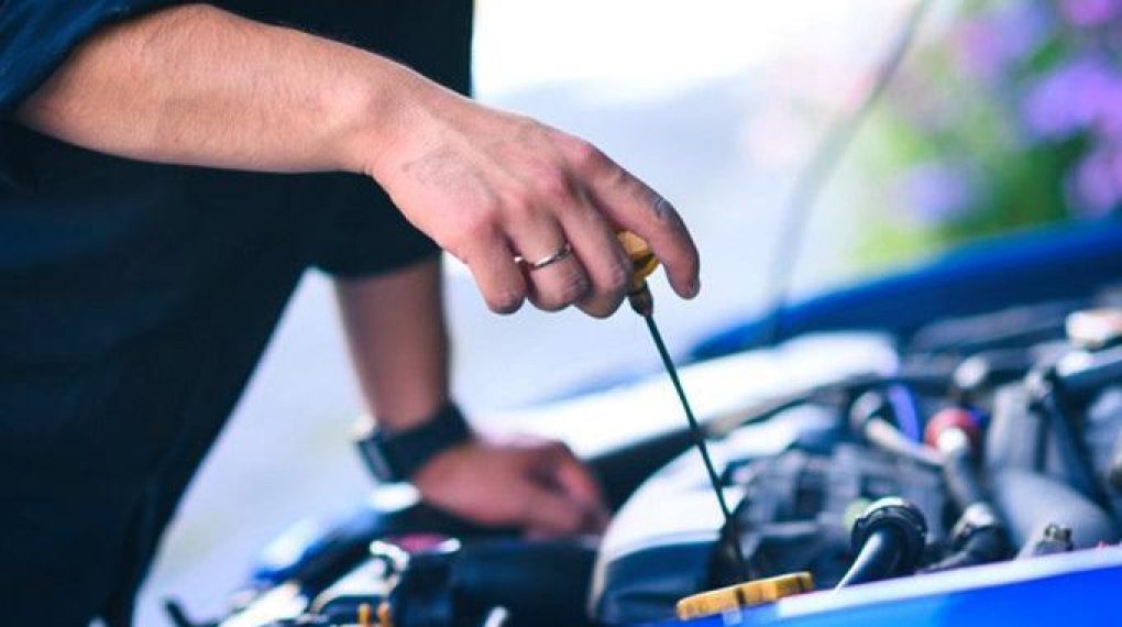 man-checking-car-engine-oil-gettyimages-680