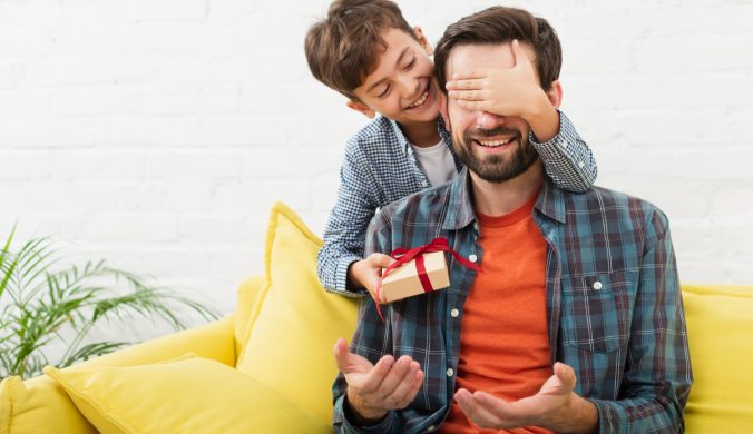 lovely son making a surprise to his father